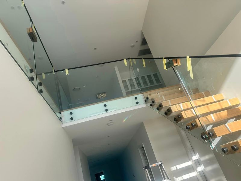 stair case with semi framed glass balustrade